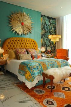 a bedroom decorated in blue and orange colors