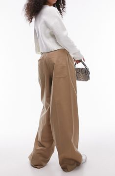 An office-official pants style clearly heads out for the weekend with a highwaist and a really roomy cut. 30 1/2" inseam; 24" leg opening; 14 1/2" front rise; 17" back rise (size 8) Zip fly with hook-and-bar closure Front slant pockets; back patch pockets 53% cotton, 47% lyocell Machine wash, dry flat Imported Baggy Full-length Bottoms For Workwear, Baggy Wide-leg Pants For Work, Baggy High-waisted Wide Leg Pants For Work, Baggy High-waisted Pants For Work, Versatile Wide-leg Cargo Pants For Workwear, Trendy Baggy Wide Leg Pants For Work, Chic Wide-leg Work Pants With Pockets, Baggy Pants For Business Casual Spring, Trendy Full Length Bottoms For Workwear