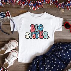 Sparkling surprise for the 4th of July! ✨ Let your little firecracker announce the exciting news with our adorable Big Sister shirts. Capture the heartwarming moment and share your growing family joy this Independence Day. Get your matching patriotic shirts now and make this announcement unforgettable! Playful T-shirt For 4th Of July With Crew Neck, Playful Crew Neck T-shirt For 4th Of July, Playful White T-shirt For 4th Of July, Playful Short Sleeve Tops For Gender Reveal, Family Matching 4th Of July T-shirt With Graphic Print, Cute 4th Of July Birthday T-shirt, Funny Short Sleeve Tops For 4th Of July, Playful Graphic Print Tops For Gender Reveal, Cute Short Sleeve Shirt For 4th Of July