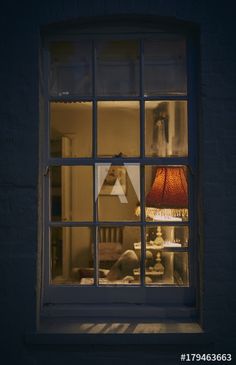 a lamp sitting on top of a window sill