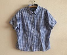 "Blue Gingham Shirt Plaid Dirndl Blouse Checkered Trachten Shirt Blue White Plaid Blouse Short Sleeve Cotton Top Plus Size Extra Large   Label size: 54/56 EUR, 28 UK Measurements (lying flat): Length: 27.5\"/ 70 cm Shoulder: 19\"/ 48 cm Pit to pit: 28\"/ 71 cm Sleeve: 9.5\"/ 24 cm Please check measurements to insure a proper fit. Remember to allow yourself some extra room for movement. You can compare these with something from your closet that fits you well. Condition: Great Vintage Condition Material: 100%cotton N.B. Color may slightly differ from picture SHIPPING * I ship worldwide via Priority mail * Items are shipped 1 - 3 business days after receiving the payment. * I ship from Europe, so please allow 2 to 4 weeks for the package to arrive if you live overseas. * Europe 5 - 10 busines Gingham Button Up Shirt Outfit, Short Sleeve Gingham Blouse For Work, Gingham Short Sleeve Blouse For Work, Classic Fitted Gingham Blouse, Short Sleeve Gingham Tops With Buttons, Fitted Gingham Blouse For Daywear, Short Sleeve Gingham Shirt For Work, Gingham Short Sleeve Shirt For Workwear, Gingham Short Sleeve Shirt For Work