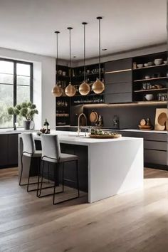 a modern kitchen with an island and hanging lights