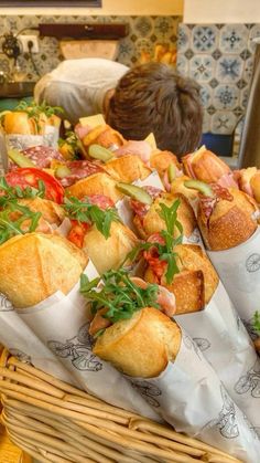 breads in baskets with toppings on them at a buffet table, ready to be eaten