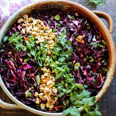 a bowl filled with red cabbage and nuts