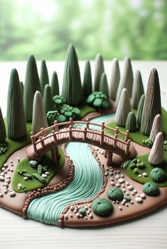 a cake that is shaped to look like a small bridge over a river and trees