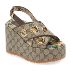 With A Nod To Heritage And '90s Style, This Cross-Strap Platform Wedge Is Crafted In Italy From Supreme Canvas With Oversized Grommets Adding A Playful Gleam. Adjustable Slingback Strap With Buckle Closure Contoured Footbed Textile Upper/Leather Lining/Rubber Sole Made In Italy Women's Designer Shoes Item # 7141047 Gucci Wedge Heel Sandals With Branded Heel, Gucci Wedge Heel Sandals, Gucci Designer Wedge Heel Sandals, Gucci Platform Heels With Round Toe, Gucci Leather Platform Sandals, Designer Platform Wedge Sandals For Spring, Gucci Platform Sandals With Ankle Strap, Gucci Designer Platform Heels, Designer Gucci Platform Heels