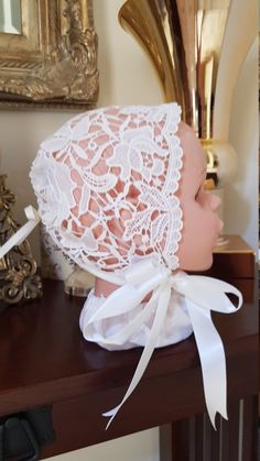 Traditional Lace Sofia bonnet with drawstring back.  Large range of laces. SIZING CHART: XS: NB-3m  S: 3-6m M: 6-9m L: 9-12m XL: 12-18m Please keep in mind these sizes work off average baby head sizes only. Many children have head sizes above or below average, so if you're unsure which size your child will need, please convo and we'll let you know which measurements we need, to check sizing.  CARE INSTRUCTIONS: Hand washable OUR PROMISE: All items lovingly handmade in a smoke- and pet-free zone, and are designed and made individually, so you can be assured of individuality.  POSTAGE: See shipping options. EXPRESS ORDERS: The standard waiting time for these items is approx 2-3 weeks. If you need your order sooner, please see our add-on listing (an additional charge) to speed up your order. Lace Baby Bonnet, Hat With Ribbon, Baby Bonnet, Baby Head, Baby Hat, Cream Lace, Ribbon Tie, Custom Baby, Photo Prop