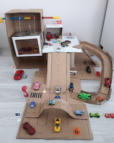 a cardboard model of a city with cars and trucks