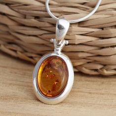 This is 925 Sterling Silver Pendant & Genuine Baltic Amber.   925 stamped            Amber size: 12 mm x 10 mm            Amber colour: cognac Approx. pendant measures:                total length: 32 mm               without bail: 22 mm               width: 15 mm Available on its own or with various length (16-26 Inch ) snake chain, please choose from the drop down menu at the top of the page. Presented in gift box. Thank you for looking! Amber Color, Baltic Amber, Snake Chain, Sterling Silver Pendants, Cognac, Silver Pendant, Jewelry Necklace Pendant, Amber, Etsy Accessories