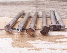 four different types of screws laying on the ground