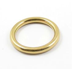 a gold ring on a white background