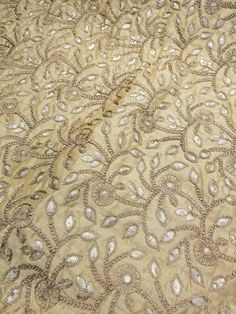 "Gold color embroidery on gold shantung fabric 54\" wide. Usable of apparel,accessories and interior designing." Luxury Bollywood Gold Embroidered Fabric, Fabric Print Design, Color Embroidery, Silk Fabrics, Interior Designing, Fabric Suppliers, Fabric Beads, Embroidery Suits, Fabric Sale