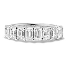 an emerald cut diamond ring with baguetts on the sides and side stones in white gold