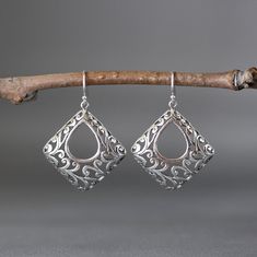 "Stunning Bali Silver filigree charms dangle from balled silver earwires. Please notice the amazing detail in the silver. These gorgeous go-with-everything statement earrings complete any outfit for daytime or evening. Bali Silver charms: 29.5x32mm Total length of earrings: 1 5/8\" All silver is sterling. As the owner, maker, designer, and curator of this shop, I take great pride in providing you with jewelry that you will love to wear everyday, for special occasions, and for many years to come. Metal Teardrop Jewelry With Intricate Design, Elegant Sterling Silver Danglers For Gift, Elegant Sterling Silver Danglers As Gift, Ornate Teardrop Jewelry With Matching Earrings, Ornate Sterling Silver Teardrop Earrings For Gift, Sterling Silver Chandelier Earrings With Intricate Design For Gift, Sterling Silver Chandelier Earrings With Intricate Design, Ornate Sterling Silver Teardrop Earrings As Gift, Elegant Pendant Earrings With Intricate Design