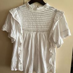 This White Free People Blouse Is Crafted From Soft Cotton Jersey Knit With A Charming Mock Neck And Delicate Lace Trim. The Short Sleeve Design Offers A Regular Fit, Making It Comfortable And Stylish Addition To Any Wardrobe. This Blouse Is Perfect For Adding A Touch Of Chic Simplicity To Your Outfit. Available In Size M With A Solid Pattern, This Versatile Top Is A Must-Have For Any Fashion-Conscious Individual. New With Tags Sold As Is, No Return And No Refund Thank You P-5 Casual Short Sleeve Blouse With Lace Collar, Casual Blouse With Lace Collar And Short Sleeves, White Crew Neck Top In Pointelle Knit, Spring Tops With Lace Collar And Short Sleeves, Fitted Pointelle Knit Tops For Daywear, Chic Tops With Lace Collar And Short Sleeves, Chic Short Sleeve Tops With Lace Collar, Casual Lace Top With Short Sleeves And Lace Collar, Casual Short Sleeve Lace Top With Lace Collar