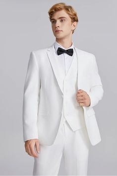 a man in a white suit and bow tie