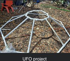 a metal frame sitting on top of a pile of wood