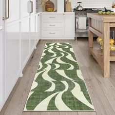 a green rug in the middle of a kitchen