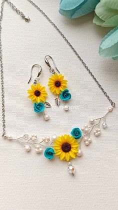 two necklaces with sunflowers and pearls on them