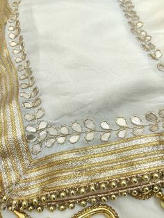 Item Overview ATHARVA Hand Embroidered/Indian Wedding Dupatta/Cream Off White Chiffon/Gota Patti Work Border/Dabka Work/Tassels/Stole/Wrap/Sarong ⚘Dno. DUP26 ⚘Hand Embroidered Gota Patti Dupatta/ Stole/ Scarf/Soft Chiffon Chinnon Dupatta ⚘Fabric Customisation: Options Available A. Net B. Organza C. Chiffon Chinnon D. Georgette E. Tabby Silk F. Pure Chiffon (Chamandi) ⚘Length: 2.5 Mtrs ⚘Width: 1.12 Mtrs ⚘Excusive Hand Embroidered Gota Patti Work ⚘Customization: * Fabrics: Designs Can be made in d Traditional Silk White Shawl, Cream Shawl-shaped Dupatta For Festive Occasions, Festive Cream Shawl-shaped Dupatta, Bohemian Cream Dupatta With Traditional Drape, Silk Shawl With Embroidered Border For Wedding, Bollywood Style Cream Dupatta With Embroidered Border, Cream Dupatta Shawl For Festive Occasions, White Bohemian Saree With Traditional Drape, Festive Cream Shawl-style Dupatta