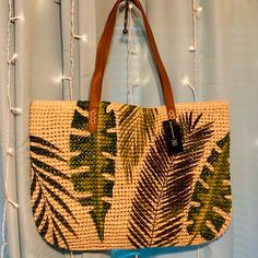 New Its Got A Beautiful Design With Oversized Palm Tree Leaves, Still In Original Packaging Great For Your Upcoming Vacation Can Fit Your Wallet, Selfie Stick, Or Camera, Sun Tan Lotions Like Everything You Need It Can Fit A Towel, Sandals Its Light To Carry And Very Durable Faux Leather Straps It Has An 11" Strap Drop 19"Wx13"H Very Roomy! Casual Green Beach Bag With Leather Handles, Casual Brown Beach Bag For Shopping, Tan Straw Bag With Braided Handles For Beach, Green Casual Beach Bag With Leather Handles, Summer Tan Straw Bag For Beach, Summer Beach Straw Bag In Tan, Summer Vacation Tan Straw Bag, Tan Shoulder Bag With Adjustable Strap For Vacation, Casual Brown Beach Bag