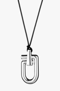 The Mega Reine necklace has been cast in Italy from polished silver and is looped through woven black cord. It features a single oversized pendant that resembles a snap hook in its most simplified form Composition: 925 Silver (47.6g) Made in Italy Size & Fit Length: 50mm Width: 26mm Thickness: 10mm Cord Length: 113cm Pre-Order Please expect a 3-week waiting period. Thank you for your patience. Care Always remove your jewellery when applying perfume, lotions and creams, or even better, always wea Luxury Black Necklaces With Detachable Pendant, Liquid Silver Necklace, Luxury Streetwear Pendant Necklace, Prada Logo Necklace, Luxury Black Enamel Pendant Necklace, Applying Perfume, 3d Jewelry, Physical Activity, Physical Activities