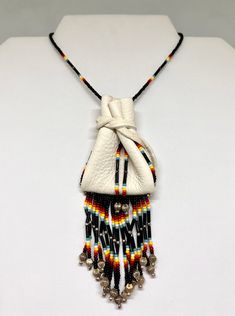 the necklace is decorated with multicolored beads and tassels on a black cord