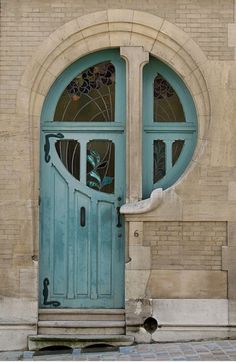 a blue door with two arched glass windows