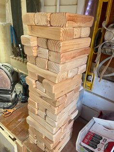 a stack of wooden planks sitting on top of a workbench in a shop