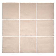 a white tile wall with several squares in it