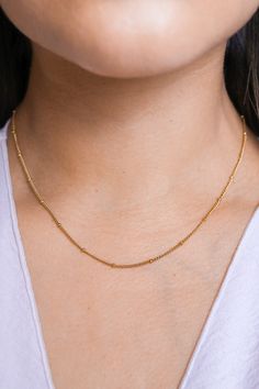 Our Brooke Bead Necklace is designed to make a subtle statement. Featuring dainty balls and a sleek chain, it completes any outfit with effortless grace. Time to give your look a "bauble" boost! All of our jewelry comes with a free jewelry pouch and cloth to keep your pretties safe and clean. Details Color: PVD 18K Gold PlatedMaterial: Stainless SteelSize: 16in + 5cm Extender Care Guide Store in a dry, cool place away from sunlight i.e. Blush & Bliss pouch Gently wipe with a soft cloth after eac Delicate Satellite Chain Necklace For Everyday, Everyday Station Necklace With Satellite Chain, Minimalist Station Necklace With Satellite Chain, Delicate Station Necklace With Satellite Chain, Everyday Station Necklace With Adjustable Chain, Minimalist Station Necklace With Cable Chain, Classic Ball Chain Necklace As Gift, Minimalist Cable Chain Station Necklace, Dainty Station Necklace With Satellite Chain