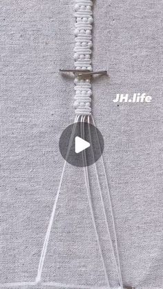 the video is showing how to make an object with yarn and buttons on top of it