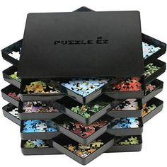 a black puzzle box filled with lots of different colored pieces on top of each other