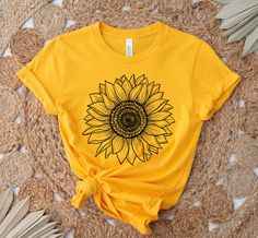 Sunflower Shirt, Sunflower T-Shirt Floral Tee Shirt Flower Shirt Garden Shirt Womens Fall Shirt Sunflower Tshirt Sunflower Shirts Sunshine This unisex t-shirt fits like a well-loved favorite. It has a soft and light feel, with just the right amount of stretch. * Made of combed and ring-spun cotton * Comfortable and flattering for both men and women SIZING * See sizing chart illustration. * If unsure as to what size to order, lay a favorite t-shirt flat and measure from armpit to armpit (width) a Sunflower T Shirt Design, Yellow T-shirt With Sunflower Design For Spring, Cotton Crew Neck T-shirt With Sunflower Design, Yellow Short Sleeve Top With Sublimation Print, Cotton Short Sleeve T-shirt With Sunflower Print, Yellow Printed Crew Neck Shirt, Sunflower Tshirt Designs, Yellow Cotton Shirt With Sublimation Print, Yellow Sublimation Print Top For Summer