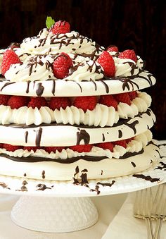 a large cake with chocolate and raspberries on top