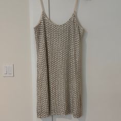 a tank top hanging on a wall next to a light switch