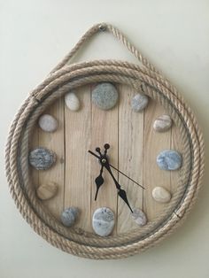 a clock made out of rope and rocks