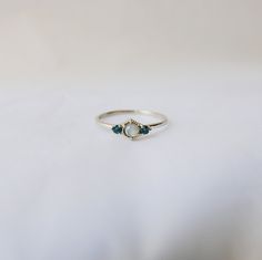 This Harlow Labradorite Ring is petite and sweet with the labradorite flanked by a London Blue Topaz on both sides. The color from the topaz pairs nicely with the glow from the labradorite. Details: Labradorite measures about 3.4mm London Blue Topaz measures about 2mm each 14k gold (available in rose, yellow or white) Simple Wedding Rings Unique, Cute Promise Rings, Unique Rings Vintage, Gold Chain Choker, Gold Topaz, Topaz Engagement Ring, London Blue Topaz Ring, Pretty Jewelry, Wedding Rings Unique