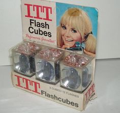 three plastic cubes in the packaging for it's flash cubes on display