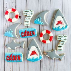 decorated cookies with shark, life preserver and crab on white wooden background for children's birthday party