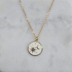 Sun and Moon necklace -Length: 18" + 2" extender. Lengthens up to 20" -Charm measurements: 15mm x 15mm  -Chain: 1.3mm flat cable chain -Finish: 14k gold filled. Tarnish resistant and water resistant. The sun shall be no more your light by day, nor for brightness shall the moon give you light; but the Lord will be your everlasting light, and your God will be your glory. -Isaiah 60:19 White Celestial Necklace With Moon Phase, White Moon Phase Celestial Necklace, White Celestial Moon Phase Necklace, White Celestial Necklace With Moon Charm, White Pendant Necklace With Sun And Moon Design, White Celestial Necklace With Adjustable Chain, Celestial White Necklace With Adjustable Chain, White Round Necklace With Sun And Moon Design, Everyday White Jewelry With Moon Charm