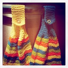 two crocheted handbags sitting on top of a counter