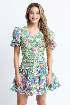 White V-neck Mini Dress With Smocked Bodice For Beach, Tropical V-neck Mini Dress For Brunch, Green V-neck Tropical Mini Dress, Tropical V-neck Dress With Vibrant Print, V-neck Tropical Dress With Vibrant Print, Tropical V-neck Dress For Brunch, Tropical V-neck Mini Dress For Vacation, V-neck Dress With Smocked Back For Vacation, Spring V-neck Dress With Palm Tree Print