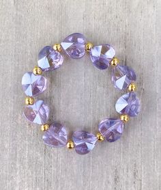 Crystal Heart Bracelet 🤍 Comes in Purple and Clear Crystal Heart beads Made with 18k filled gold beads  The cutest layering piece ✨  CARING TIPS FOR YOUR JEWELRY ⭐️Treat and store with care. ⭐️ For longevity, avoid exposing your jewelry to water. ⭐️ Avoid having direct contact with lotions, perfumes, sanitizers as these chemicals may cause discoloration of your jewelry. Heart Bracelet Gold, Gold And Purple, Bracelet Heart, Purple Crystal, Purple Crystals, Heart Beads, Bracelet Gold, Crystal Heart, Heart Bracelet