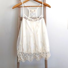 Brand New With Tags, Ivory Camisole With Beaded Lace Overlay, Size Xs Features Racer Back Style, Lace Overlay With Gorgeous Beaded And Sequin Detail Made Of 52% Cotton, 48% Nylon (Outer Layer) 100% Polyester (Cami) Measures Approximately 15" From Armpit To Armpit 26" From Shoulder To Hem Embellished Fitted Sleeveless Camisole, White Camisole Halter Top For Spring, White Camisole Halter Top For Summer, Fitted Embellished Sleeveless Camisole, Embellished Summer Vest, Elegant Embellished Sleeveless Camisole, Spring Sleeveless Lace Top With Delicate Straps, White Sleeveless Lace Top With Delicate Straps, White Halter Top With Tank Straps For Spring