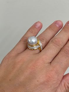 An 18 karat yellow gold and platinum ring set with a 13.1mm South Sea pearl, and approximately 1.34ctw of G.VS diamonds. Retail is $24,100. DESIGNER: Assael MATERIAL: 18k Yellow Gold / Platinum GEMSTONES: Pearl, Diamond DIMENSIONS: Ring size 6.5, Top is 18mm wide. MARKED/TESTED: 750, Cummings, Assael, PT950 WEIGHT: 20 grams CONDITION: Previously Owned / Excellent Condition Timeless Diamond Pearl Ring With Prong Setting, Timeless Diamond White Brilliant Cut Pearl Ring, Timeless Diamond White Pearl Ring With Brilliant Cut, Timeless Pearl Ring With Diamond Accents, Timeless Diamond Pearl Ring With Center Stone, Diamond Pearl Ring With Pave Setting For Formal Events, Diamond Pearl Ring With Pave Setting For Formal Occasions, Formal Diamond Pearl Ring With Pave Setting, Timeless Brilliant Cut Pearl Ring For Anniversary