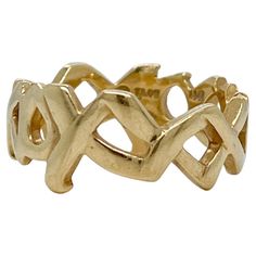 A fine Graffiti 'Love & Kisses' band ring. Designed by Paloma Picasso for Tiffany & Co. With alternating XXXs and OOOs in 18k yellow gold. Simply a terrific ring! Date: 20th Century Overall Condition: It is in overall good, as-pictured, used estate condition with some fine & light surface scratches and other signs of expected light wear consistent with age. Fineness: Marked 18k for gold fineness. Marks: © T&Co / Paloma Picasso / 750 / 18k Measurements: Diameter: ca. 22 Width: ca. 7 mm Weight: ca Tiffany Love Ring Paloma, Gold Graffiti, Love And Kisses, Vintage Spoon Rings, Paloma Picasso, Vintage Spoons, Love Kiss, Tiffany And Co, Paloma