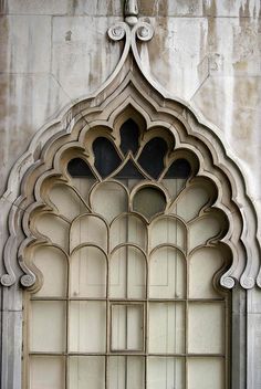 an old window with arched glass on the outside