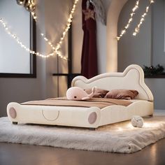 a bed that is sitting on top of a white rug and some lights in the background