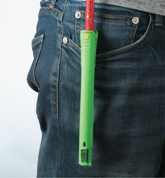 an electric toothbrush sticking out of the back pocket of someone's jeans